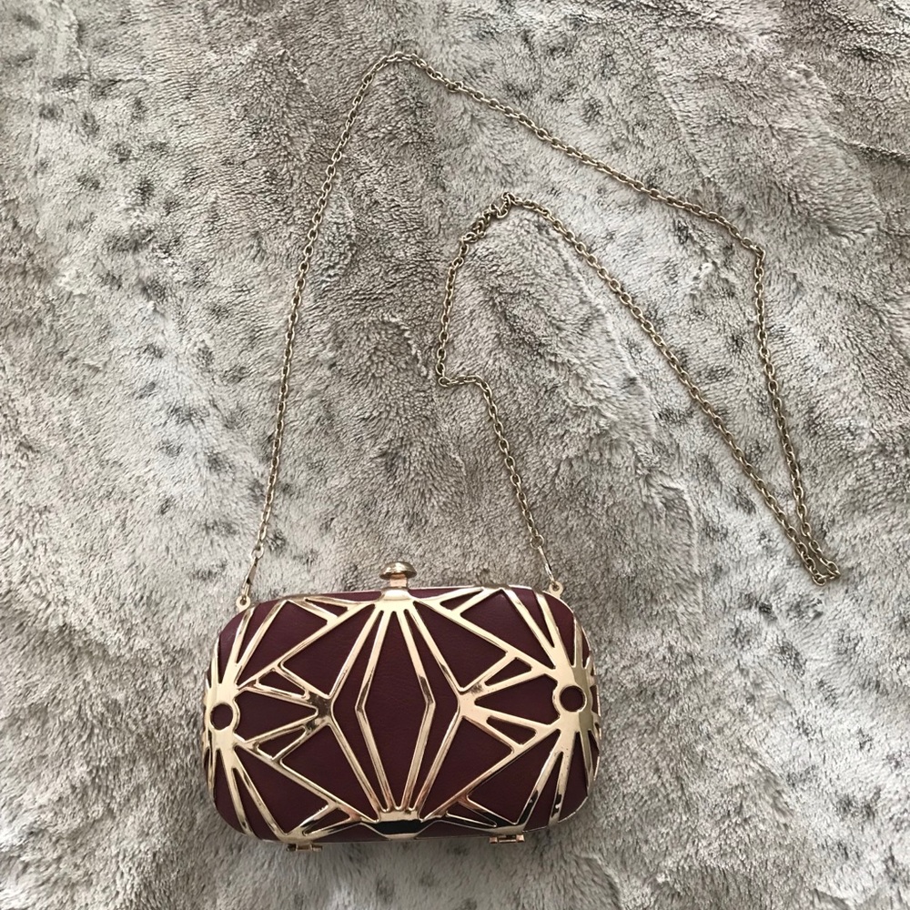 Burgundy evening clutch with gold metal detail